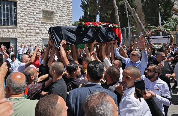 The body of of slain veteran Al-Jazeera journalist Shireen Abu Akleh arrives at a hospital in the east Jerusalem neighbourhood of Sheikh Jarrah, on May 12, 2022. - Abu Akleh, who was shot dead on May 11, 2022 while covering a raid in the Israeli-occupied West Bank, was among Arab media's most prominent figures and widely hailed for her bravery and professionalism. (Photo by AHMAD GHARABLI / AFP) (Photo by AHMAD GHARABLI/AFP via Getty Images)