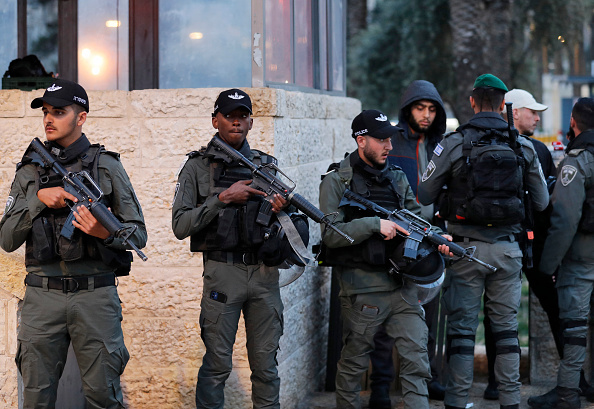 Israeli security forces check the IDs of Palestinian youths outside Damascus' Gate in Jerusalem's Old City on March 8, 2022 a day after a knife-wielding Palestinian stabbed and wounded two Israeli policemen before being shot dead by forces at the site. (Photo by Ahmad GHARABLI / AFP) (Photo by AHMAD GHARABLI/AFP via Getty Images)